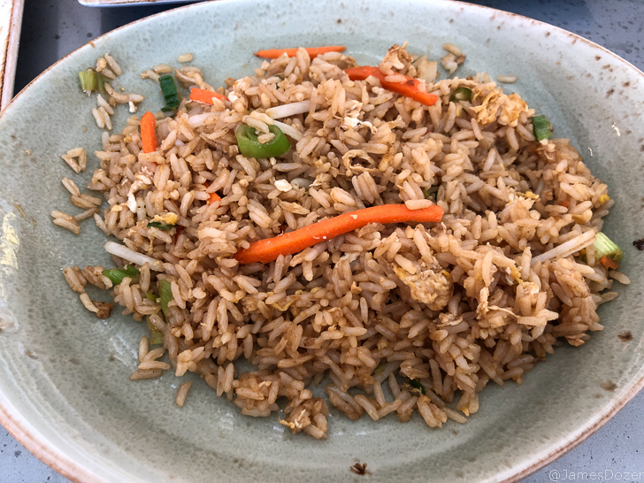 a plate of rice with vegetables
