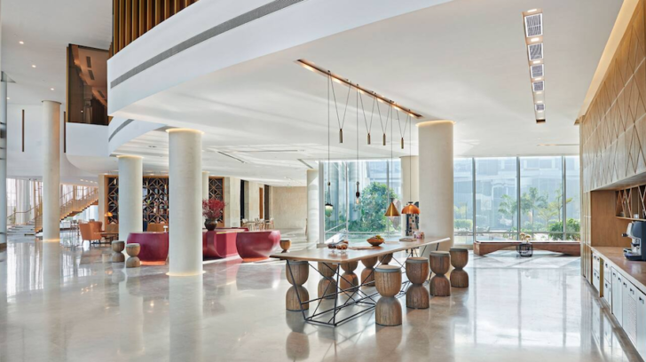 a large room with a table and stools