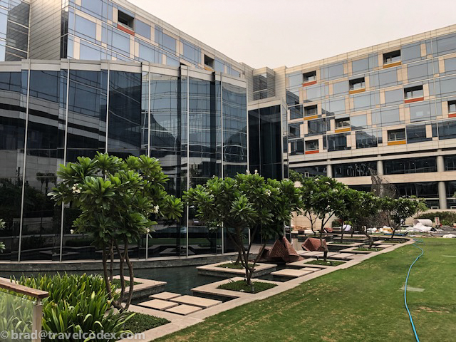 a building with a glass wall and trees