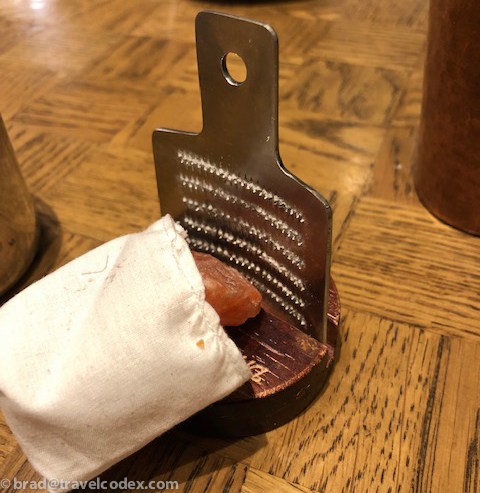 a piece of food on a cheese grater
