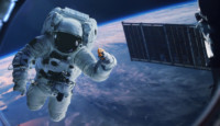 an astronaut in space with a satellite in the background
