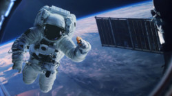 an astronaut in space with a satellite in the background