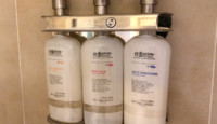 a group of white bottles on a metal shelf