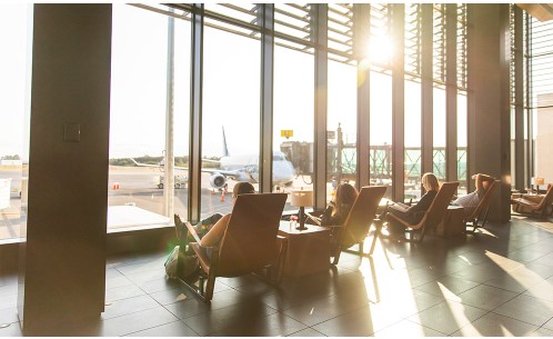 people sitting in chairs in a terminal