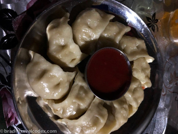 a plate of dumplings with sauce