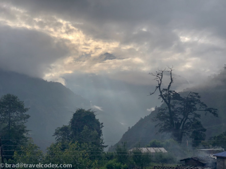 a cloudy sky over a valley