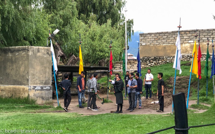 a group of people standing around flags