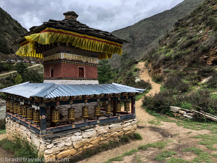 a small building with prayer wheels