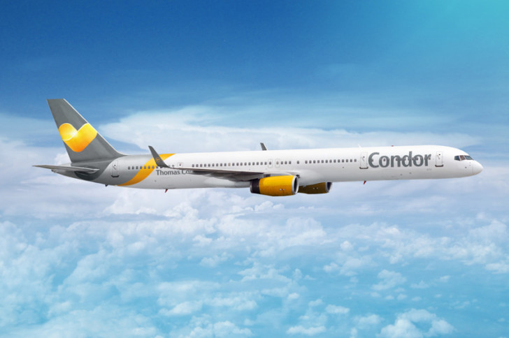 a white and yellow airplane flying in the sky