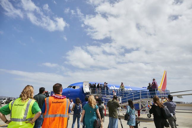 a group of people standing on a plane