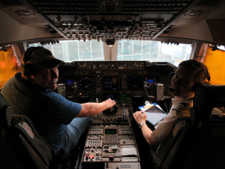 a couple of men in the cockpit of an airplane