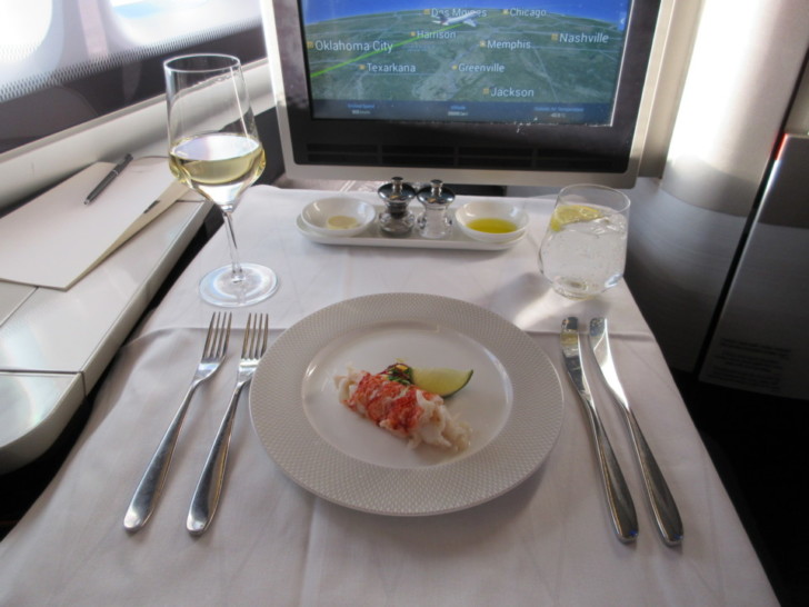 a plate of food on a table with a computer screen