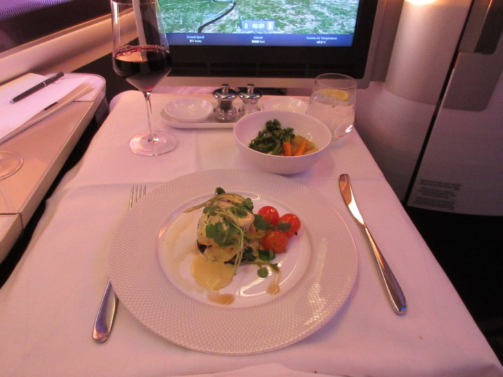 a plate of food and a glass of wine on a table