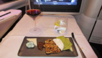 a plate of food and a glass of wine on a table