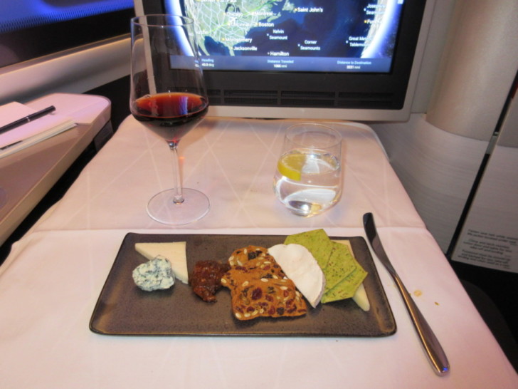 a plate of food and a glass of wine on a table