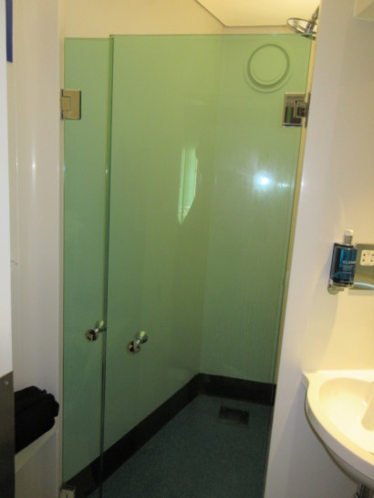 a glass shower door in a bathroom