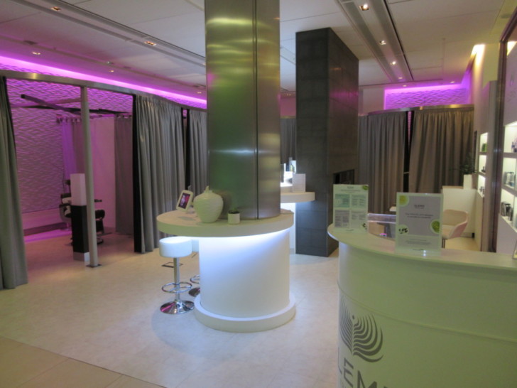 a room with a reception desk and purple lights