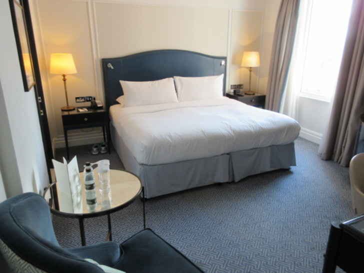 a hotel room with a bed and a table
