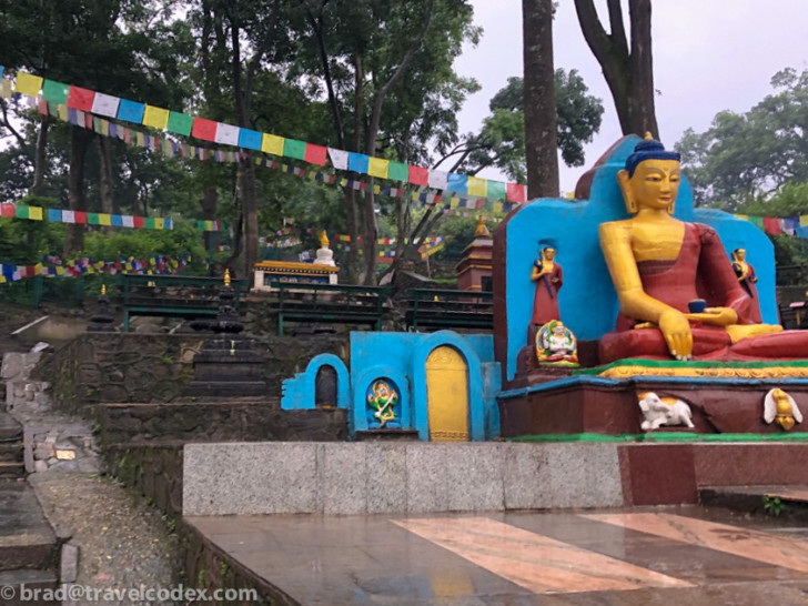 a statue of a buddha in a park
