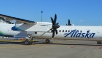 a white airplane with blue writing