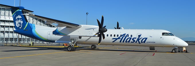 a white airplane with blue writing