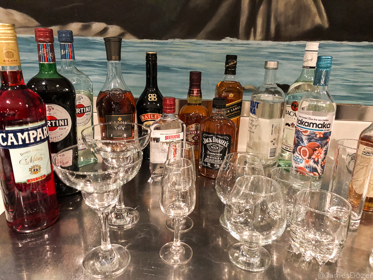 a group of bottles and glasses on a table