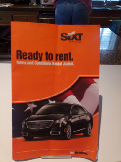 an orange sign with a picture of a car on it