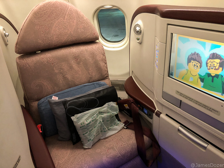 a seat with a television and a screen in the back