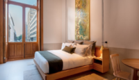a bed with a wood frame and a map on the wall