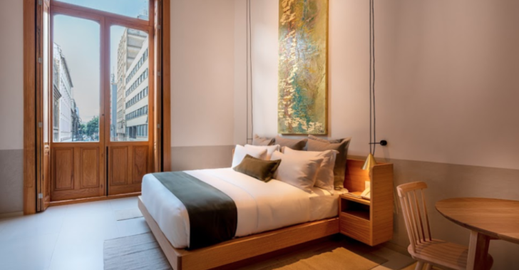 a bed with a map on the wall