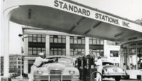 a man filling a car at a gas station