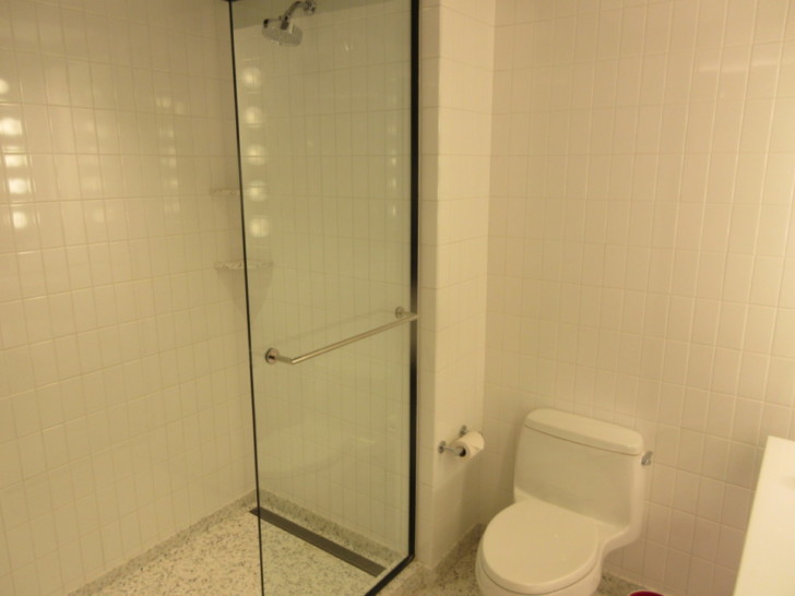a bathroom with a glass shower door