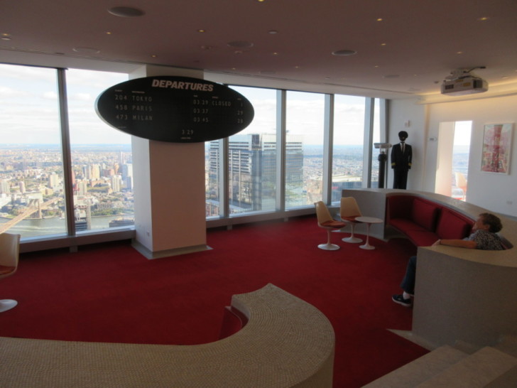 a room with red carpet and a black sign