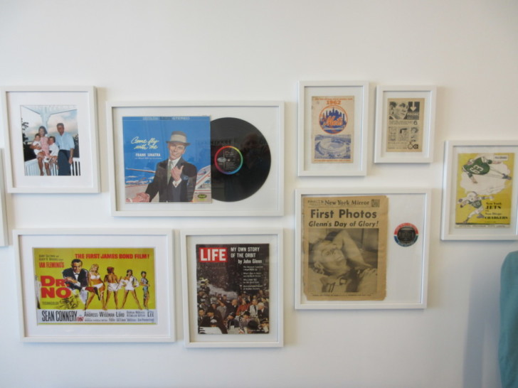 a wall with pictures of various people