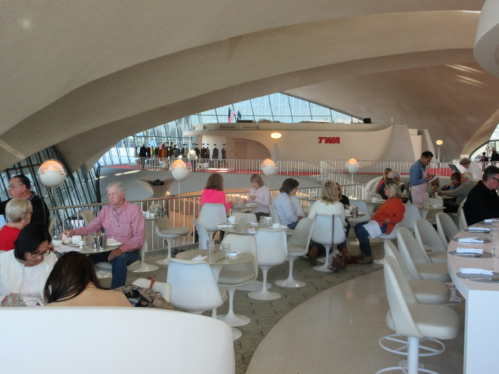 people sitting at tables in a restaurant