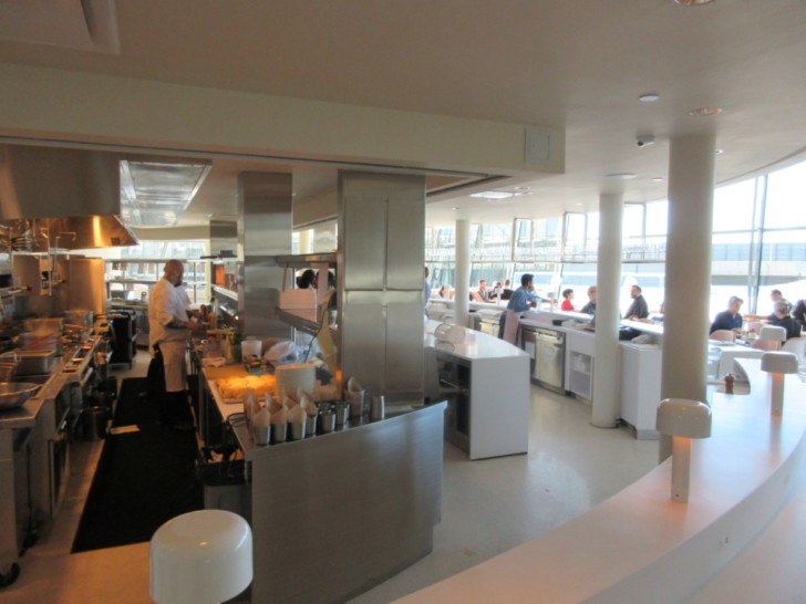 a restaurant kitchen with people in the background