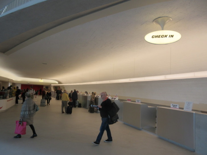 people walking in a check in area