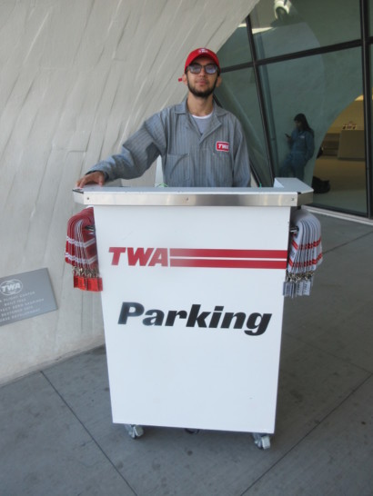 a man standing behind a white sign