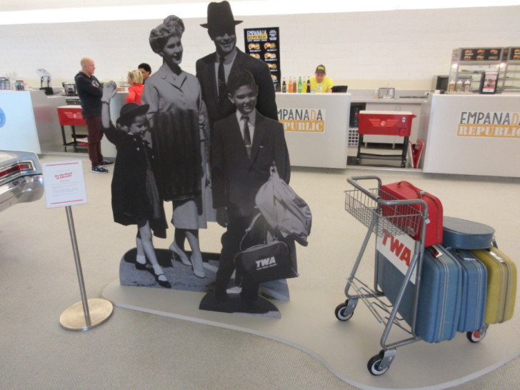 a cardboard cutout of a family with luggage