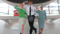 a man in uniform and stewardess saluting with other people