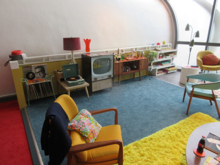 a room with a yellow chair and a yellow rug
