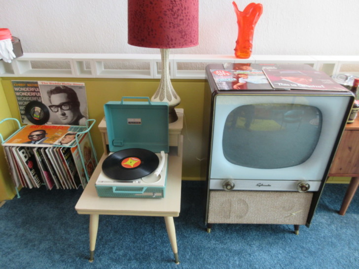 a table with a record player and a television