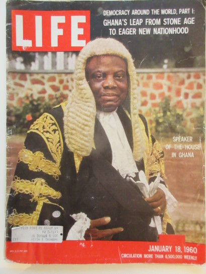 a magazine cover with a man wearing a wig and a white shirt