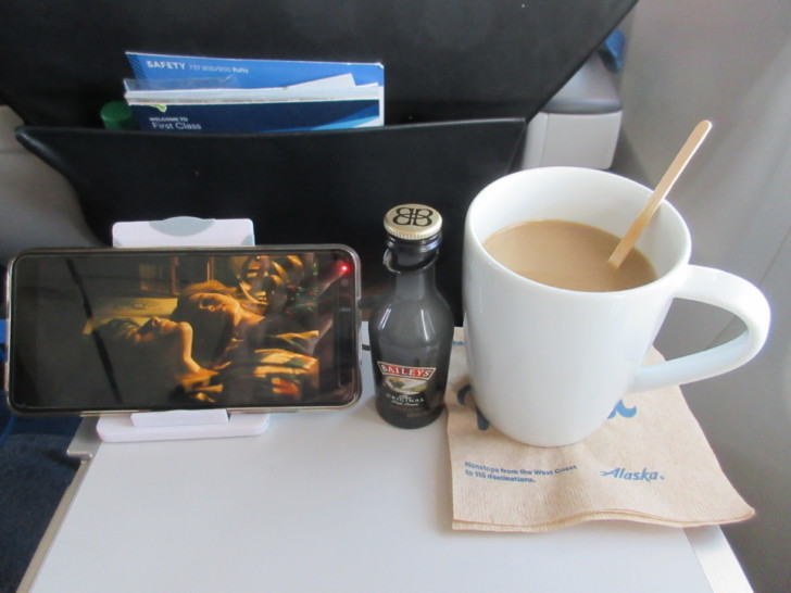 a cup of coffee and a tablet on a table