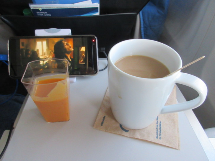 a coffee mug and a phone on a table