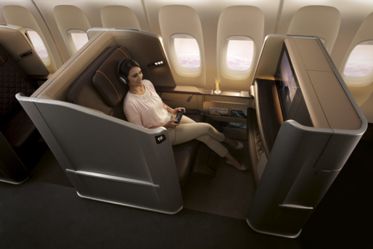 a woman sitting in a chair in a plane