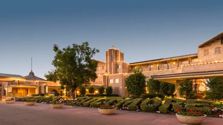 a building with lights and bushes