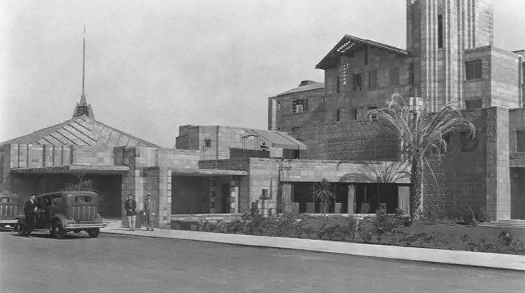 a couple of people walking in front of a building