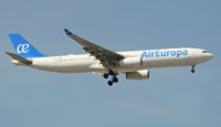 a white airplane flying in the sky