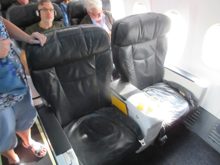 a group of people sitting in an airplane